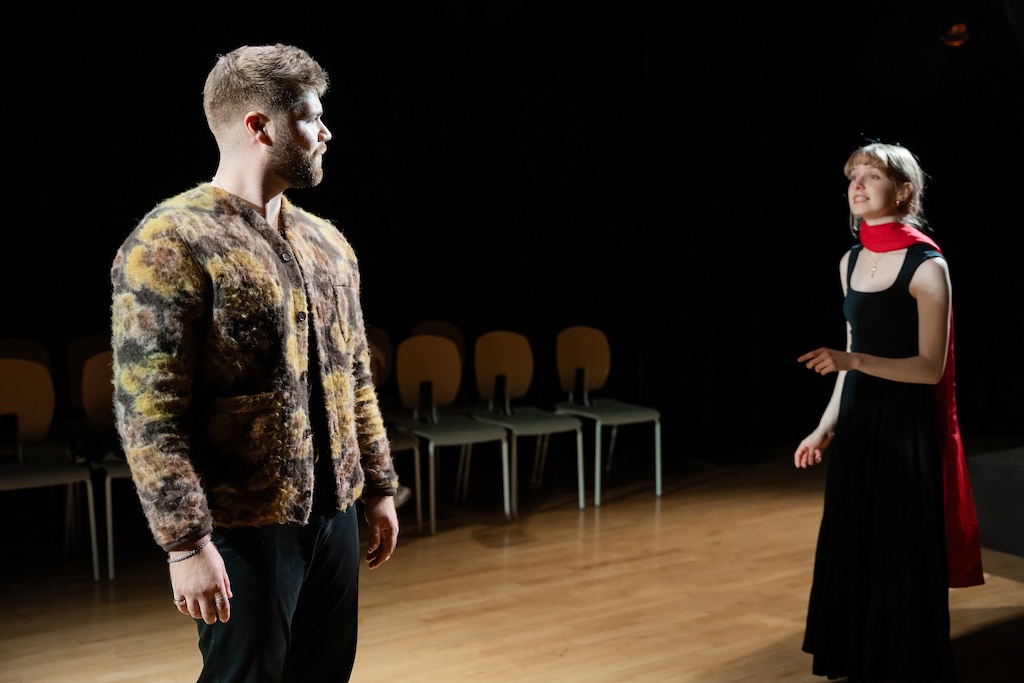 Two actors standing and looking toward one another on stage during the final presentation of The Winter's Tale.